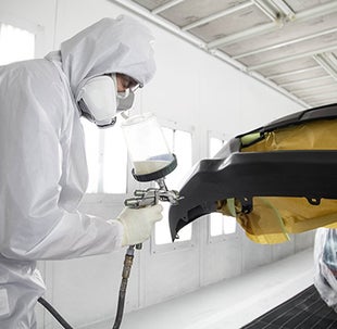 Collision Center Technician Painting a Vehicle | Fiore Toyota in Hollidaysburg PA
