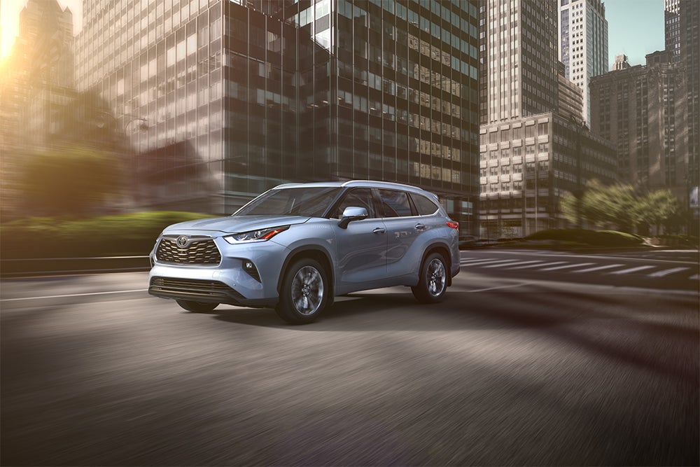 The 2020 Toyota Highlander coming soon to Fiore Toyota of Hollidaysburg | Blue 2020 toyota highlander running on road