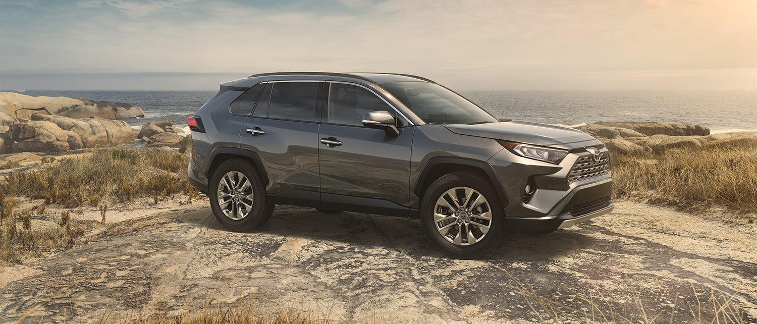 Comparison of the Toyota RAV4 and the Honda CR-V crossovers at Fiore Toyota | Gray Toyota RAV4 parked on road