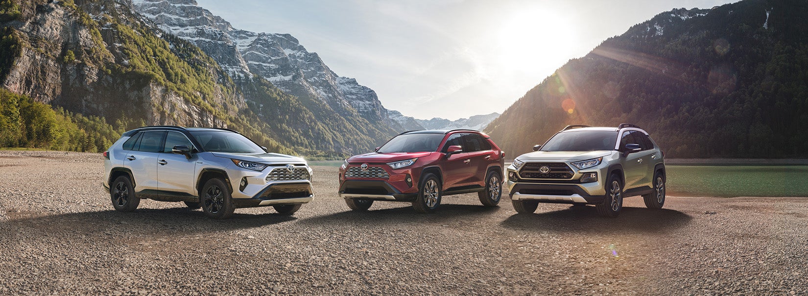 A Hybrid for Everyone at Fiore Toyota | three toyota RAV4 parked on road