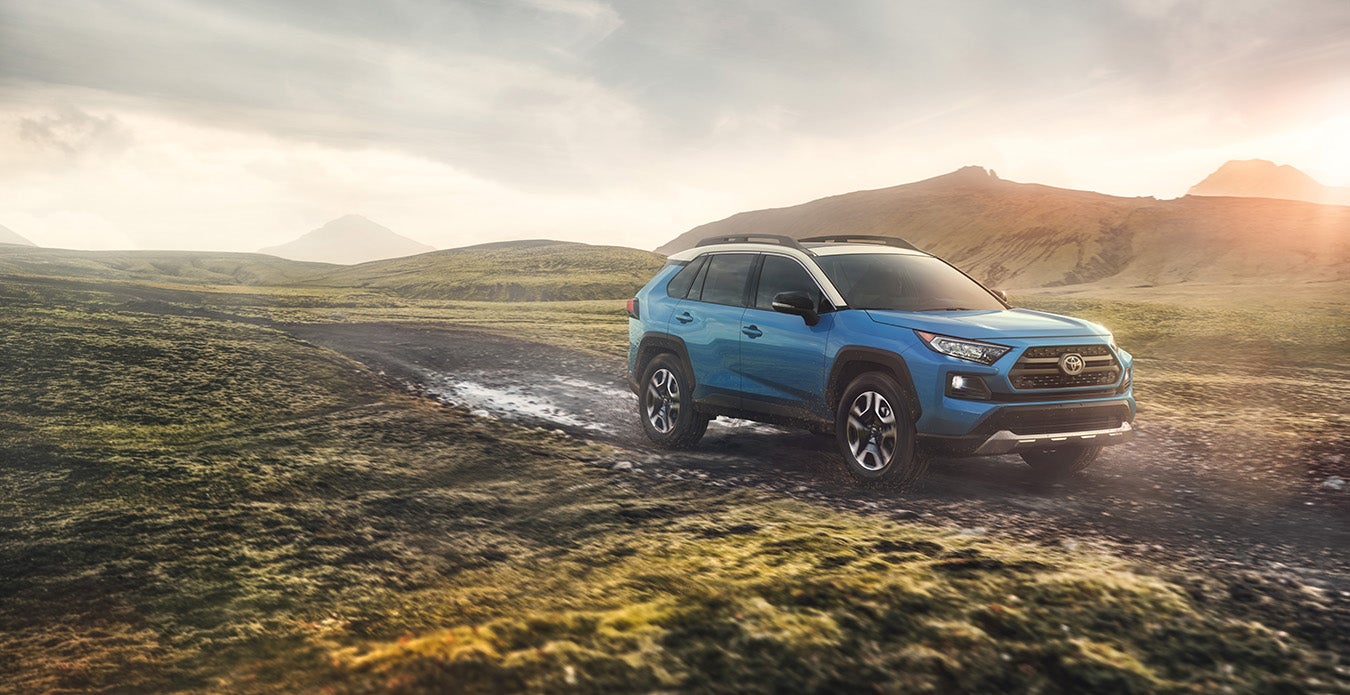 A Hybrid for Everyone at Fiore Toyota | blue Toyota RAV4 running on road