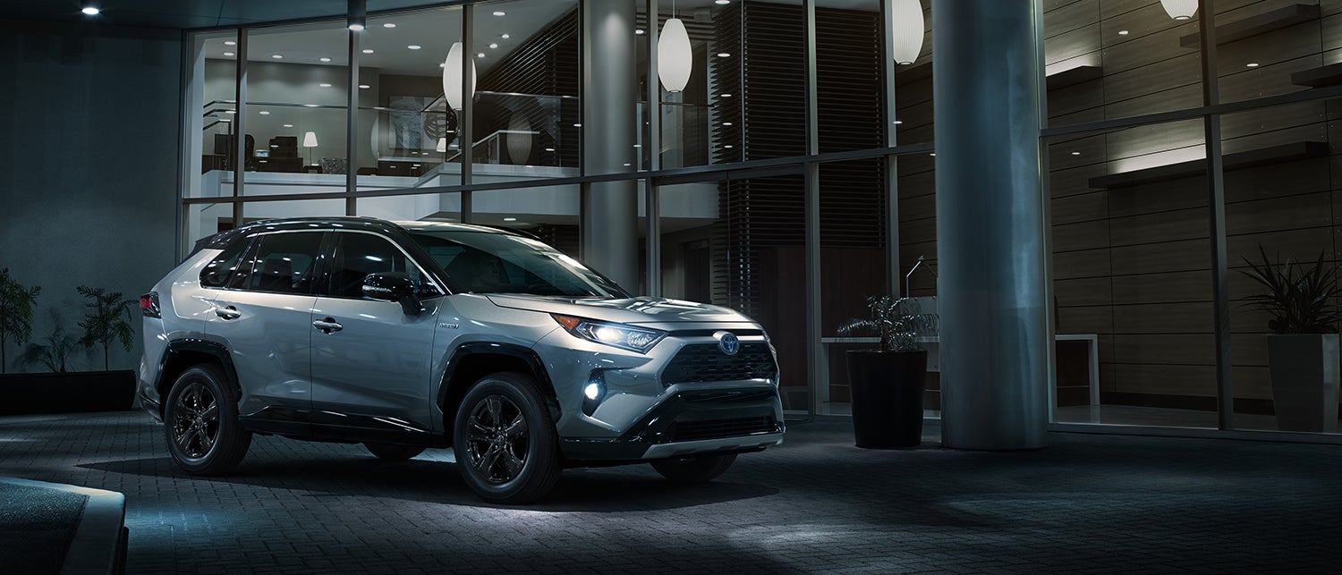 A Hybrid for Everyone at Fiore Toyota | Sliver Toyota RAV4 park on road
