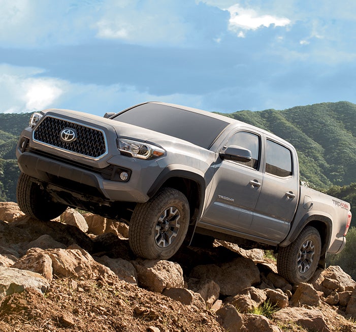 Comparison of the Toyota Tacoma vs. Tundra trucks at Fiore Toyota of Hollidaysburg | Toyota Tacoma on top of rocky hill