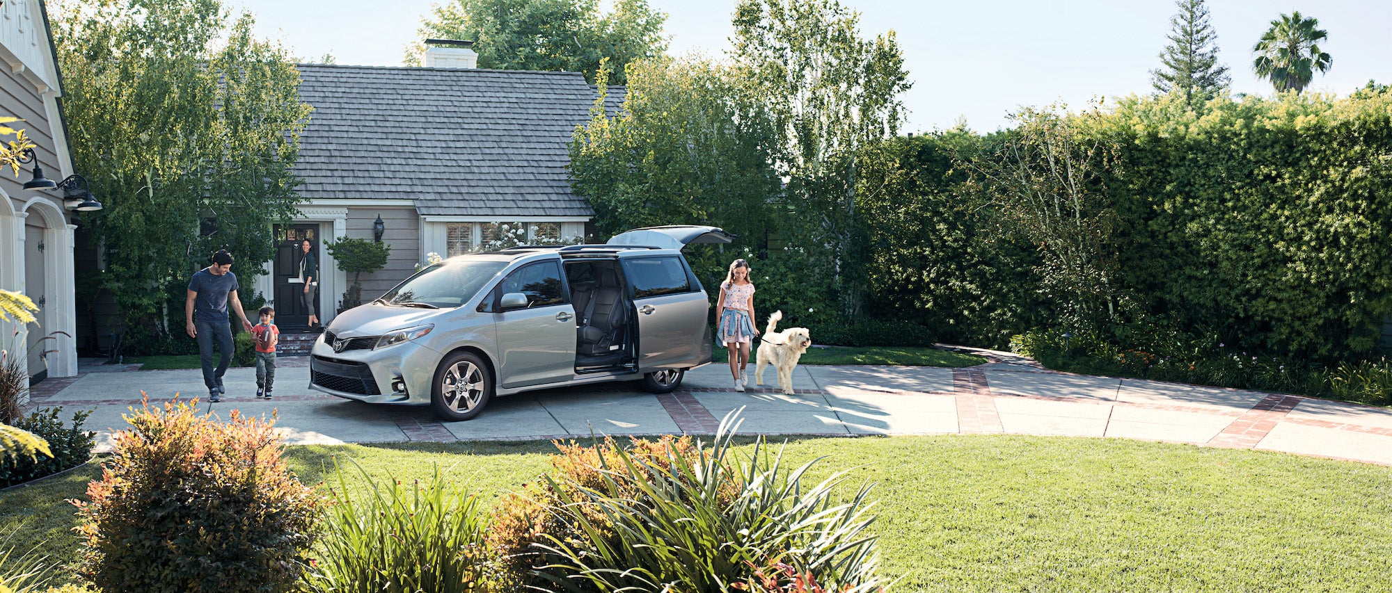 Compare the 2020 Toyota Sienna with the 2020 Honda Odyssey Fiore Toyota of Hollidaysburg | Family gathering around the 2020 Sienna