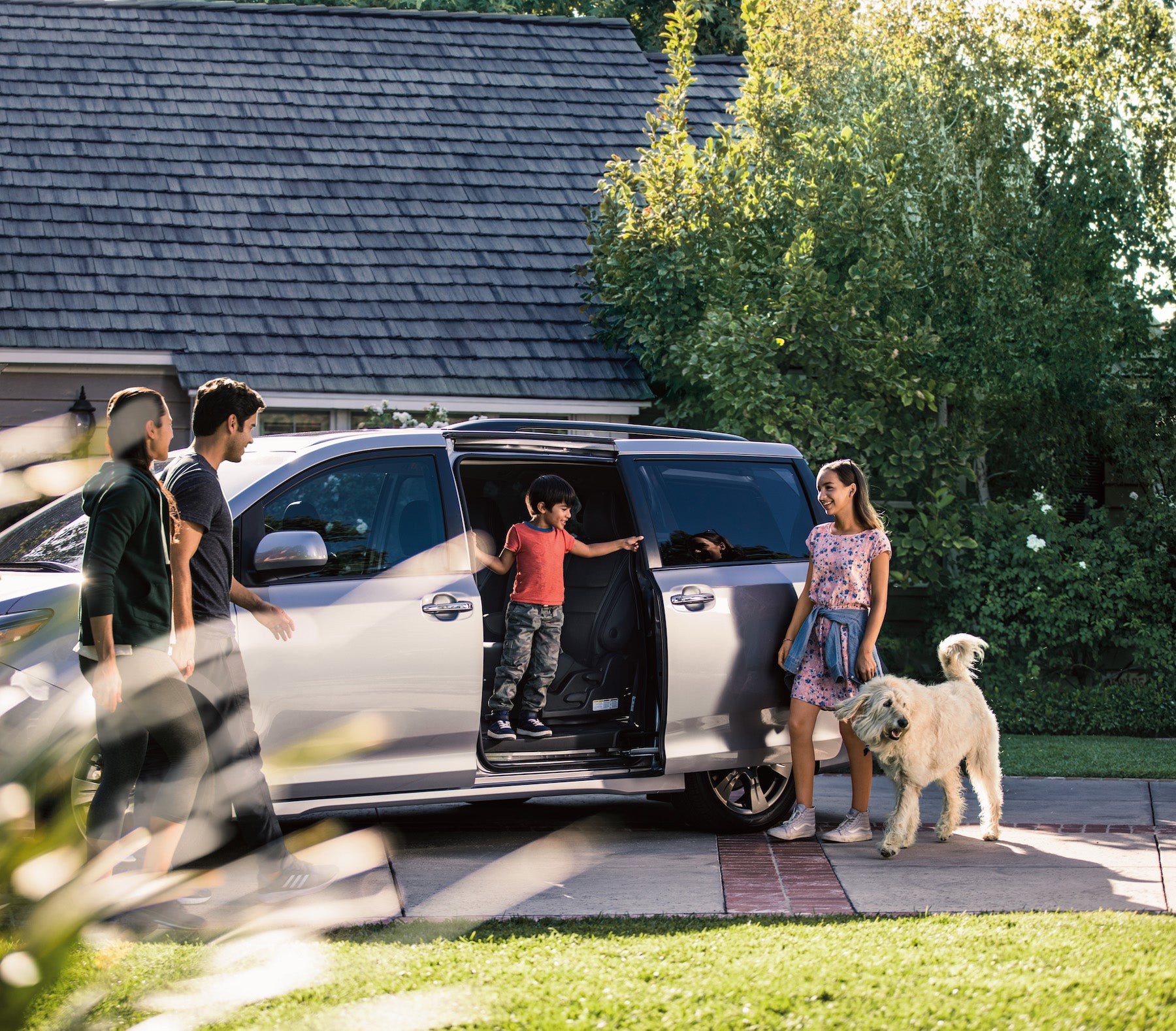 Compare the 2020 Toyota Sienna with the 2020 Honda Odyssey Fiore Toyota of Hollidaysburg | Family gathering around the 2020 Sienna