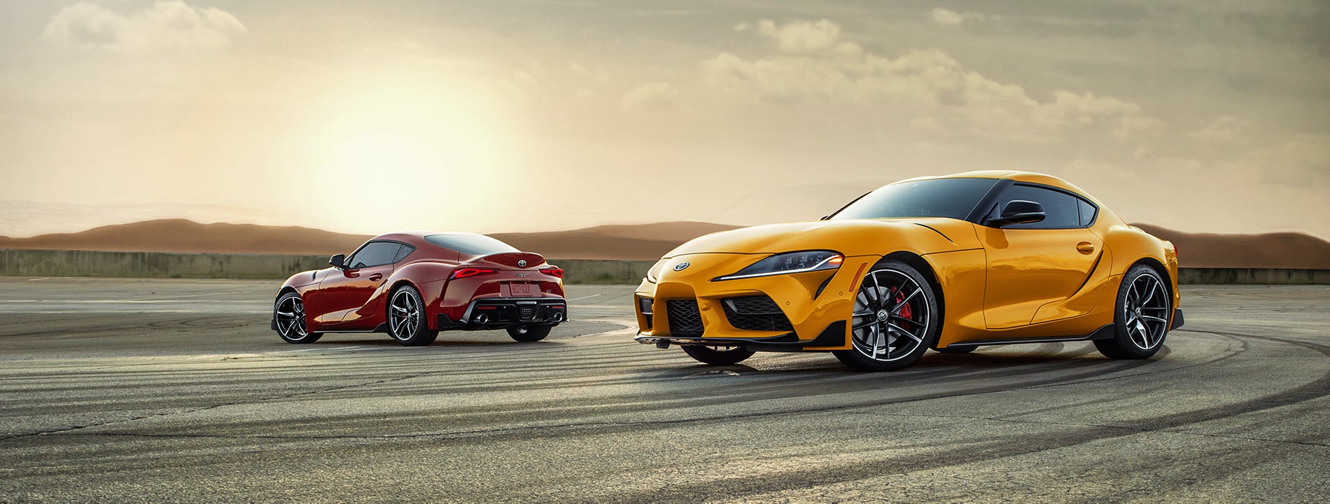 Performance features of the 2020 Supra at Fiore Toyota in Hollidaysburg | Red and Yellow 2020 GR Supra parked on a lot