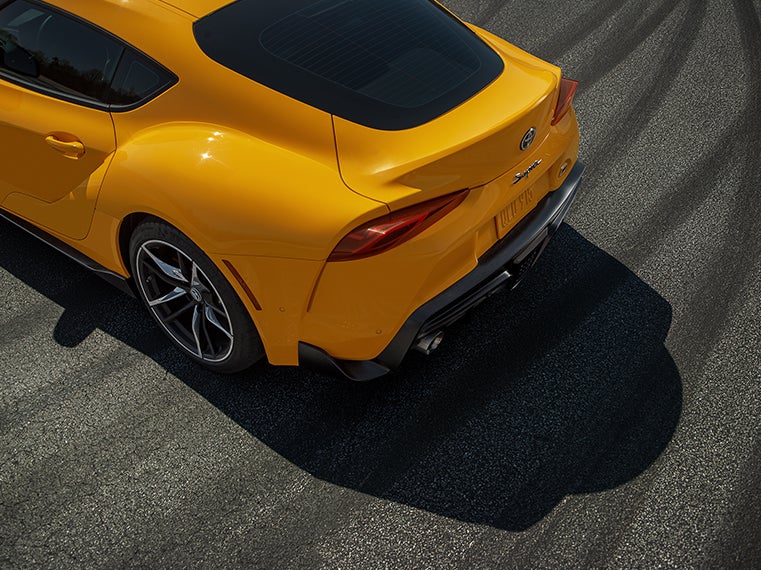 Performance features of the 2020 Supra at Fiore Toyota in Hollidaysburg | Yellow 2020 GR Supra tail end