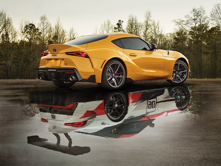 Performance features of the 2020 Supra at Fiore Toyota in Hollidaysburg | Yellow 2020 GR Supra side profile with sport car relfection