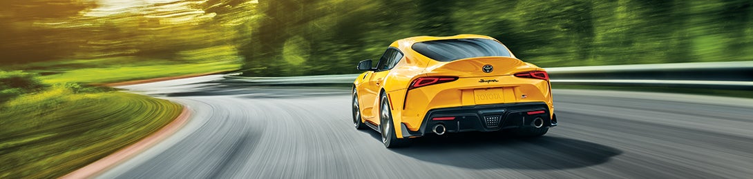 Performance features of the 2020 Supra at Fiore Toyota in Hollidaysburg | Yellow 2020 GR Supra running on road