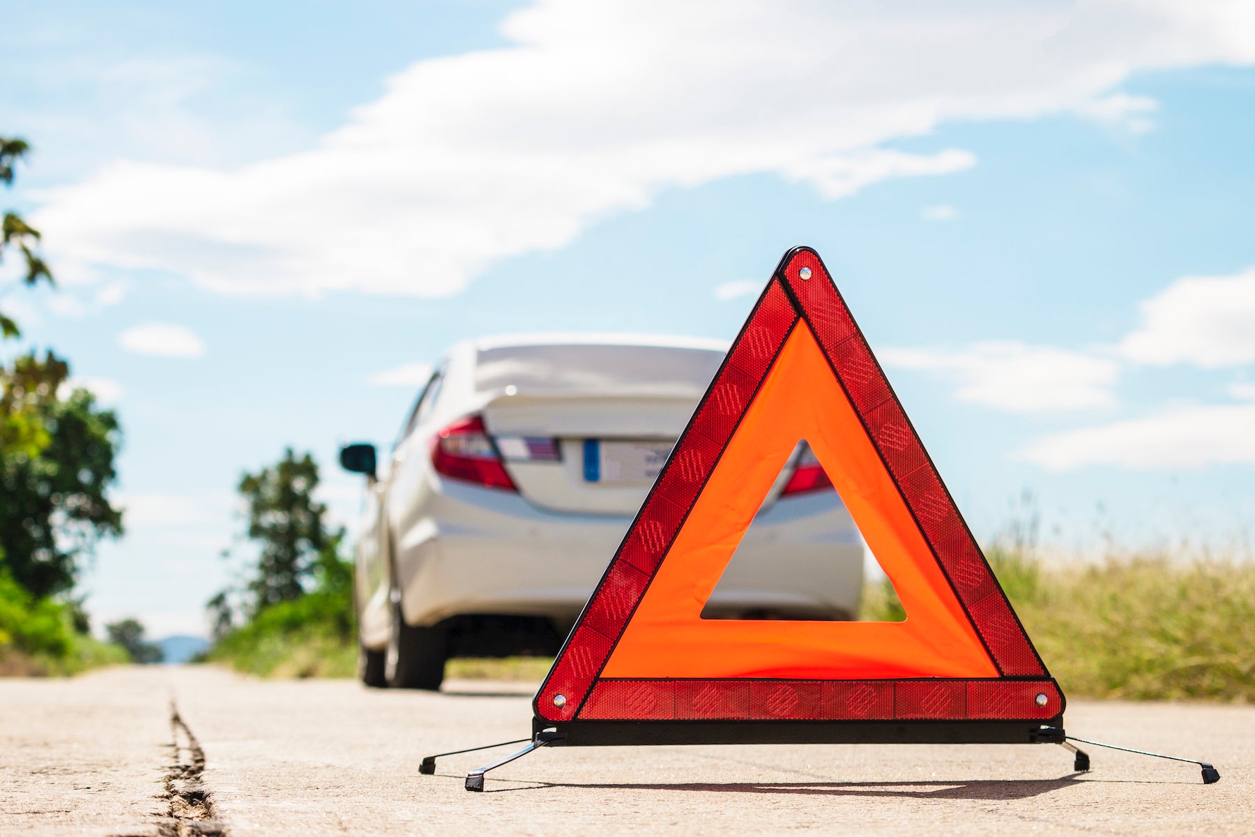 How to change a tire step-by-step guide at Fiore Toyota in Hollidaysburg | Hazard sign behind a car