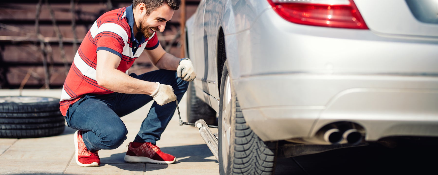How to change a tire step-by-step guide at Fiore Toyota in Hollidaysburg | man changing car tire