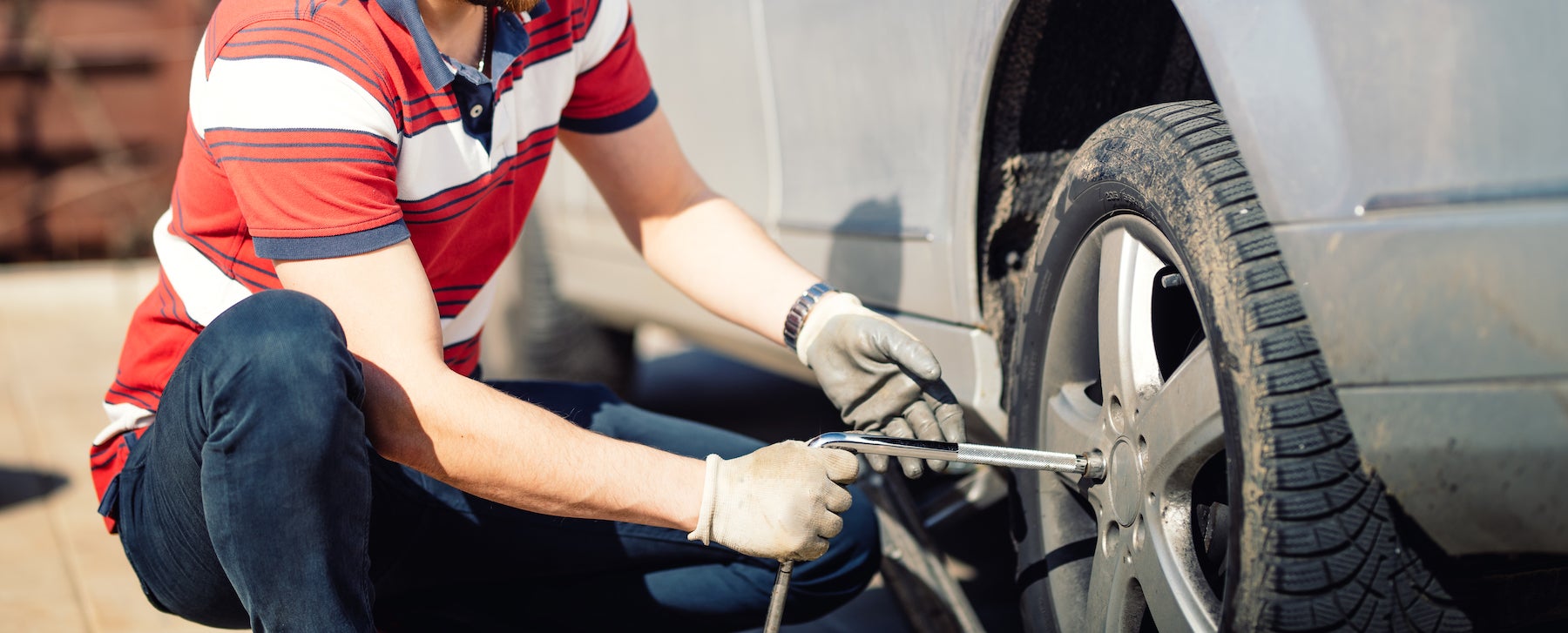How to change a tire step-by-step guide at Fiore Toyota in Hollidaysburg | man changing car tire